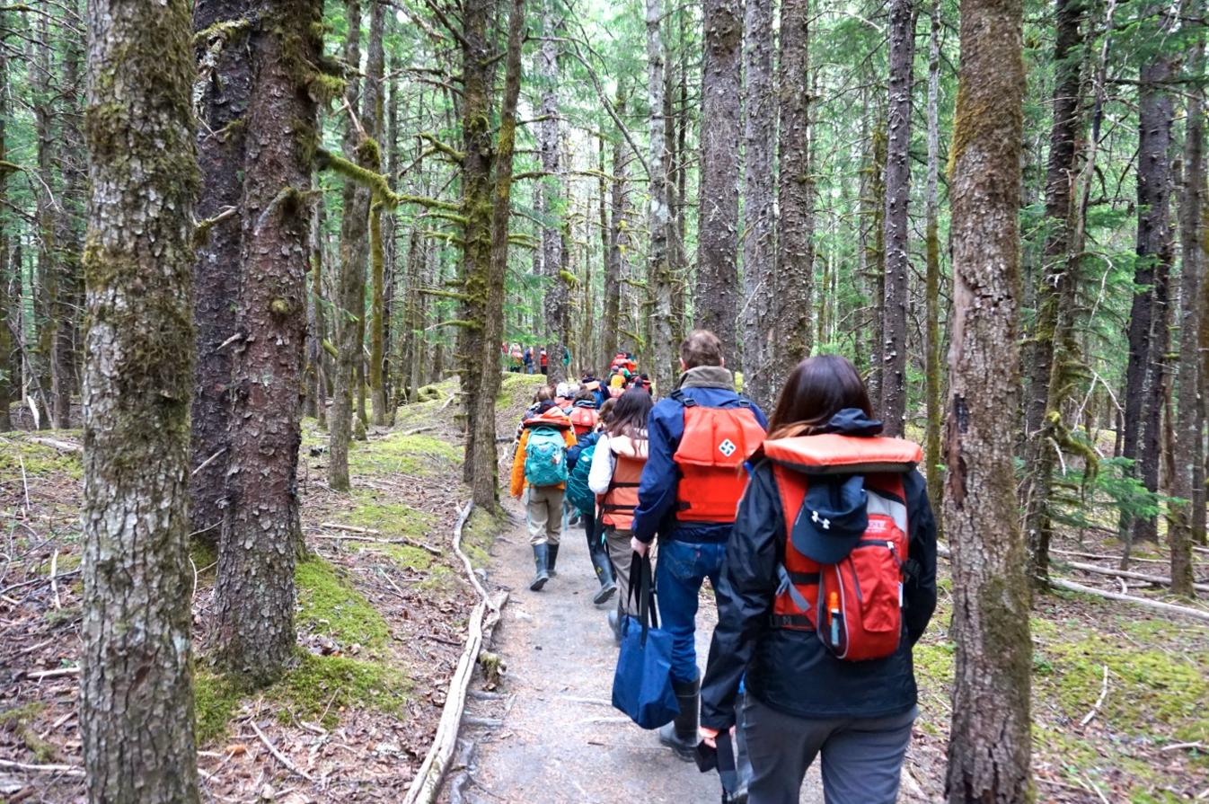 Students hike through an Alaskan forest