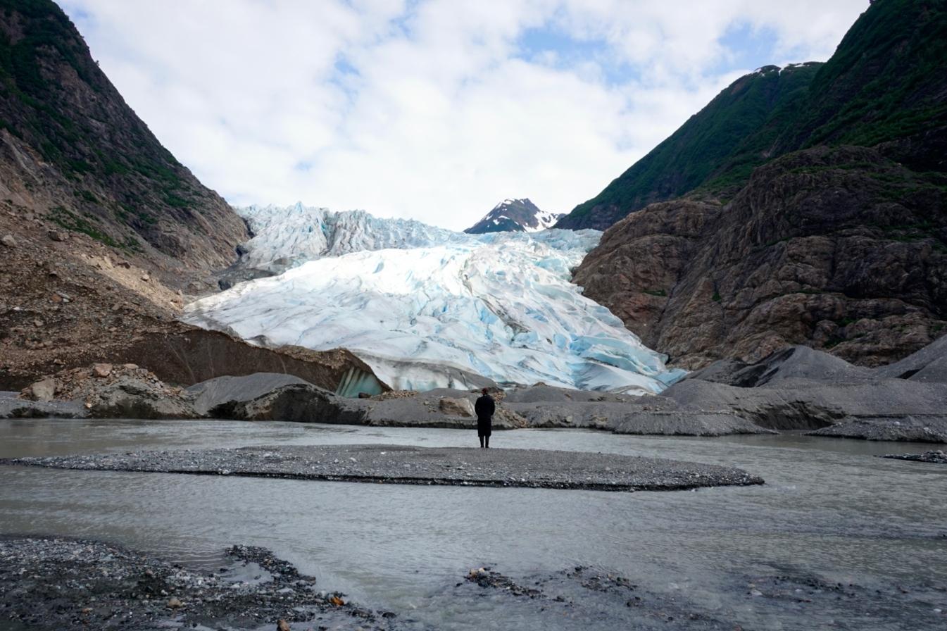 Student Alex looking at an Alaskan Glacier on a field course
