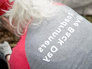 An MSU Denver volunteer wearing a shirt which reads, 