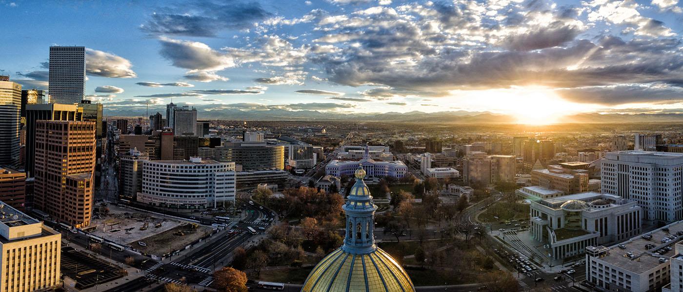 View of Denver from above at sunset with capitol building in foreground
