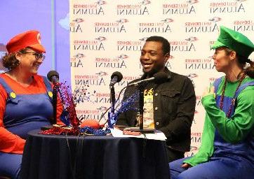 Brandi Rideout and Jamie Hurst dressed in Mario and Luigi costumes, talking with Damarley Laing during the 2023 Day of Giving telethon